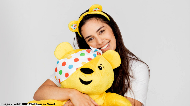 Oxford Brookes student Rosie wears Pudsey ears and hugs a Pudsey bear